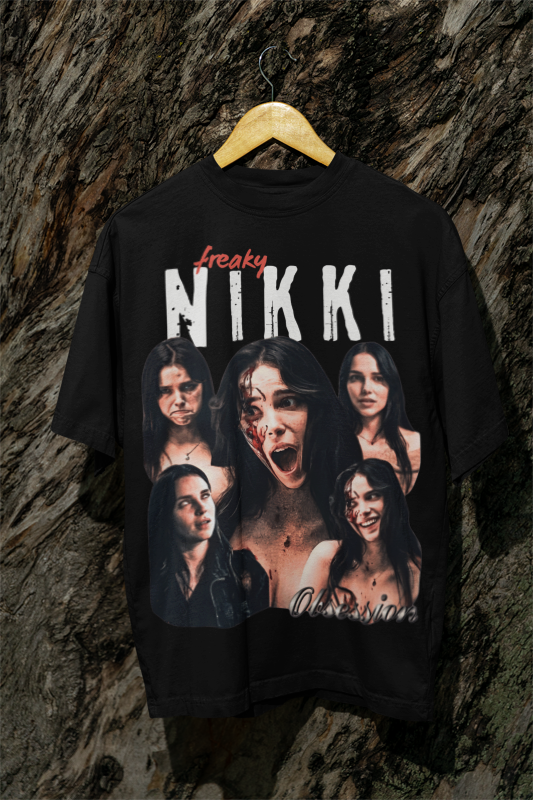 A black OBSESSION graphic t-shirt that features a large front print with the text 'freaky NIKKI' in white and red, and a collage of five of Nikki's Freaky facial expressions with the word 'Obsession' written in cursive at the bottom.